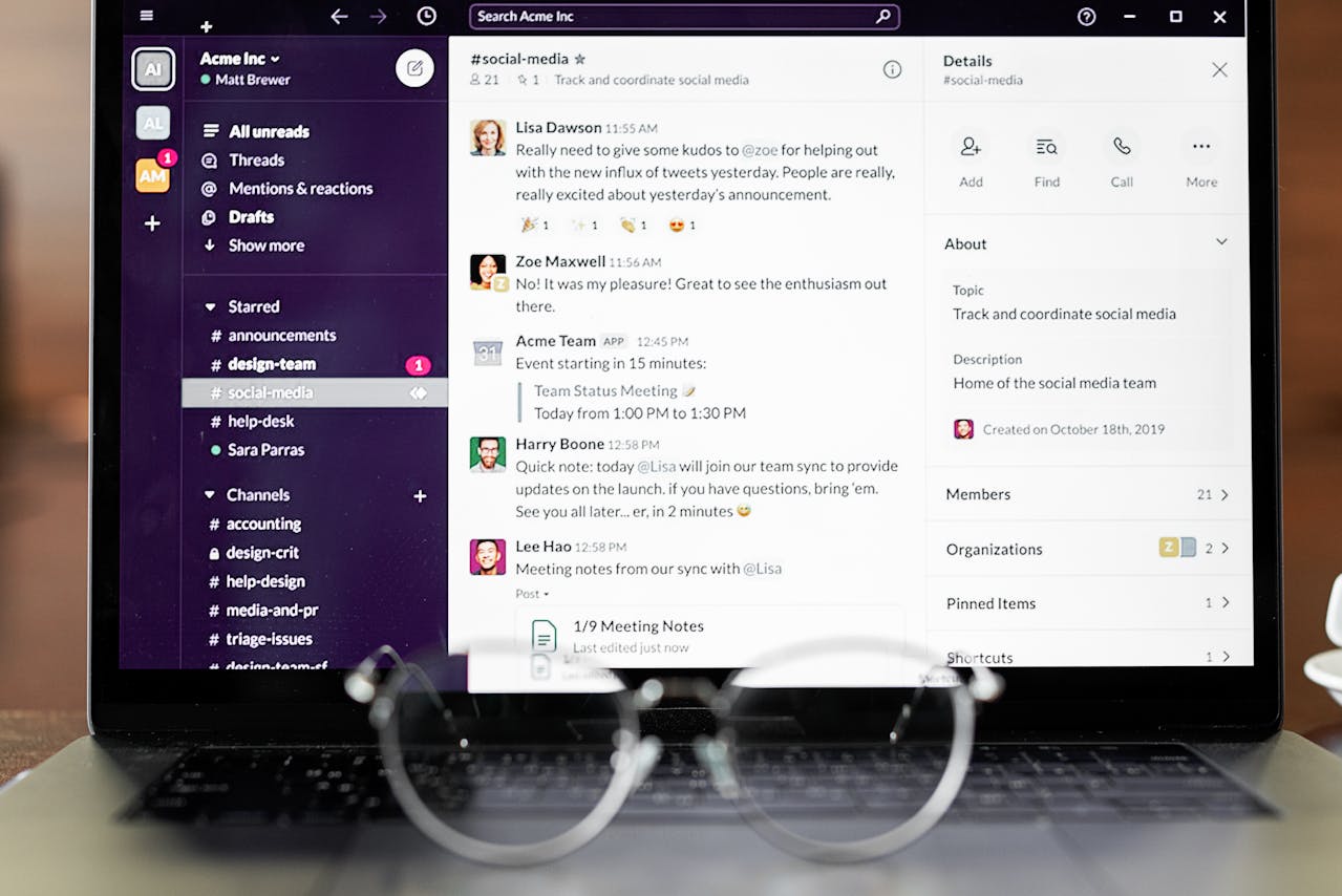 Laptop screen displaying a Slack workspace with a social media team discussion and notifications.