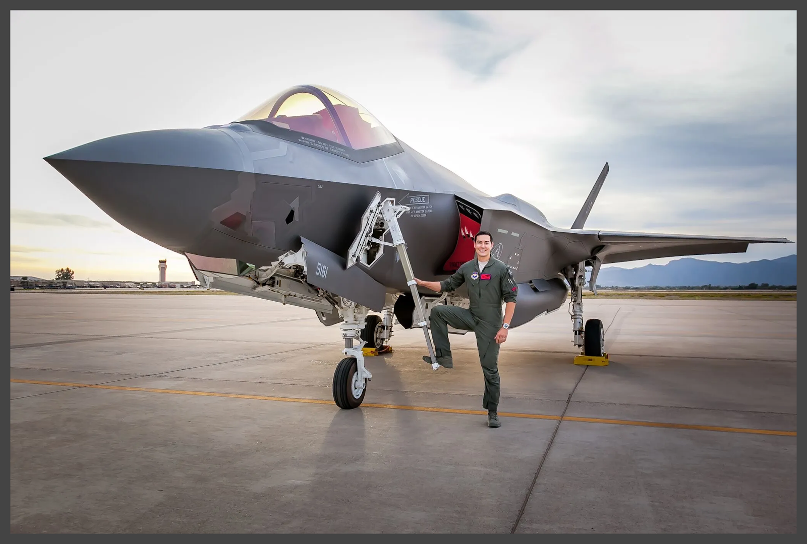 A person standing next to a jet

Description automatically generated