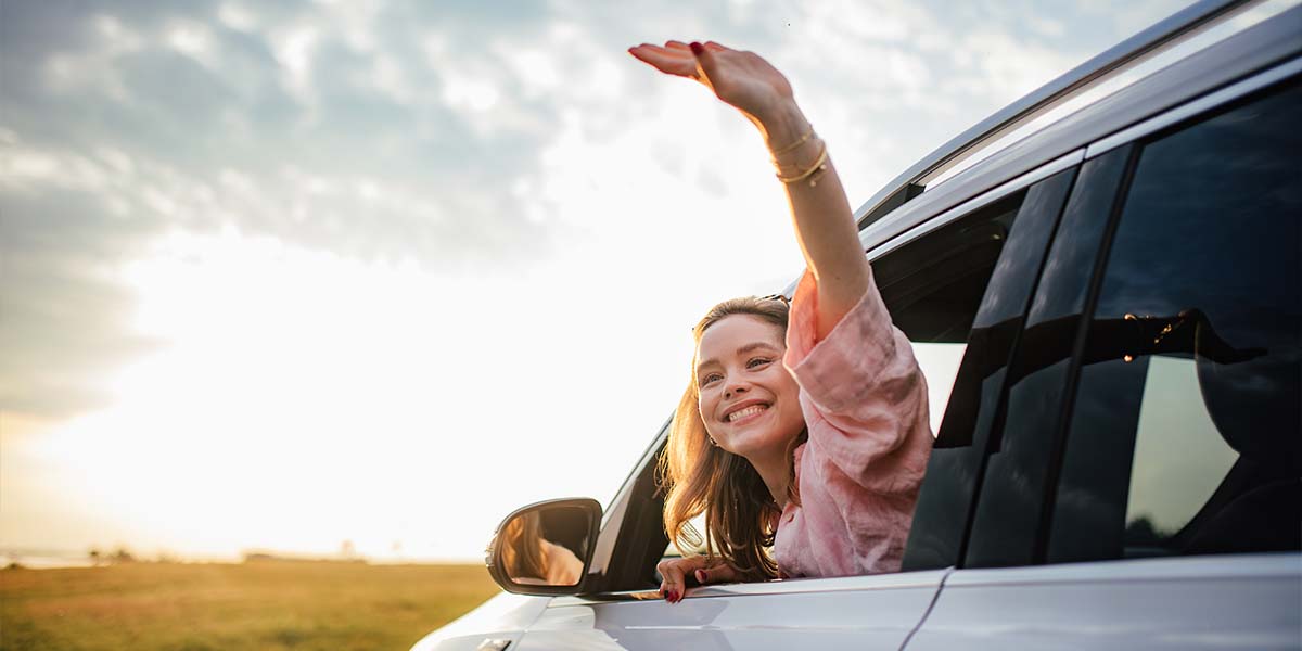 Happy girl driving new car