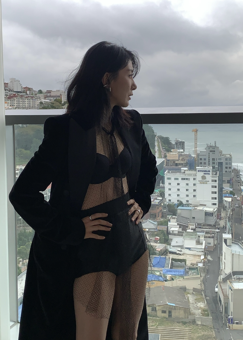 Kim Seo Hyung rocked a lingerie-inspired ensemble featuring a bra top and bottom, paired with a long coat and mesh