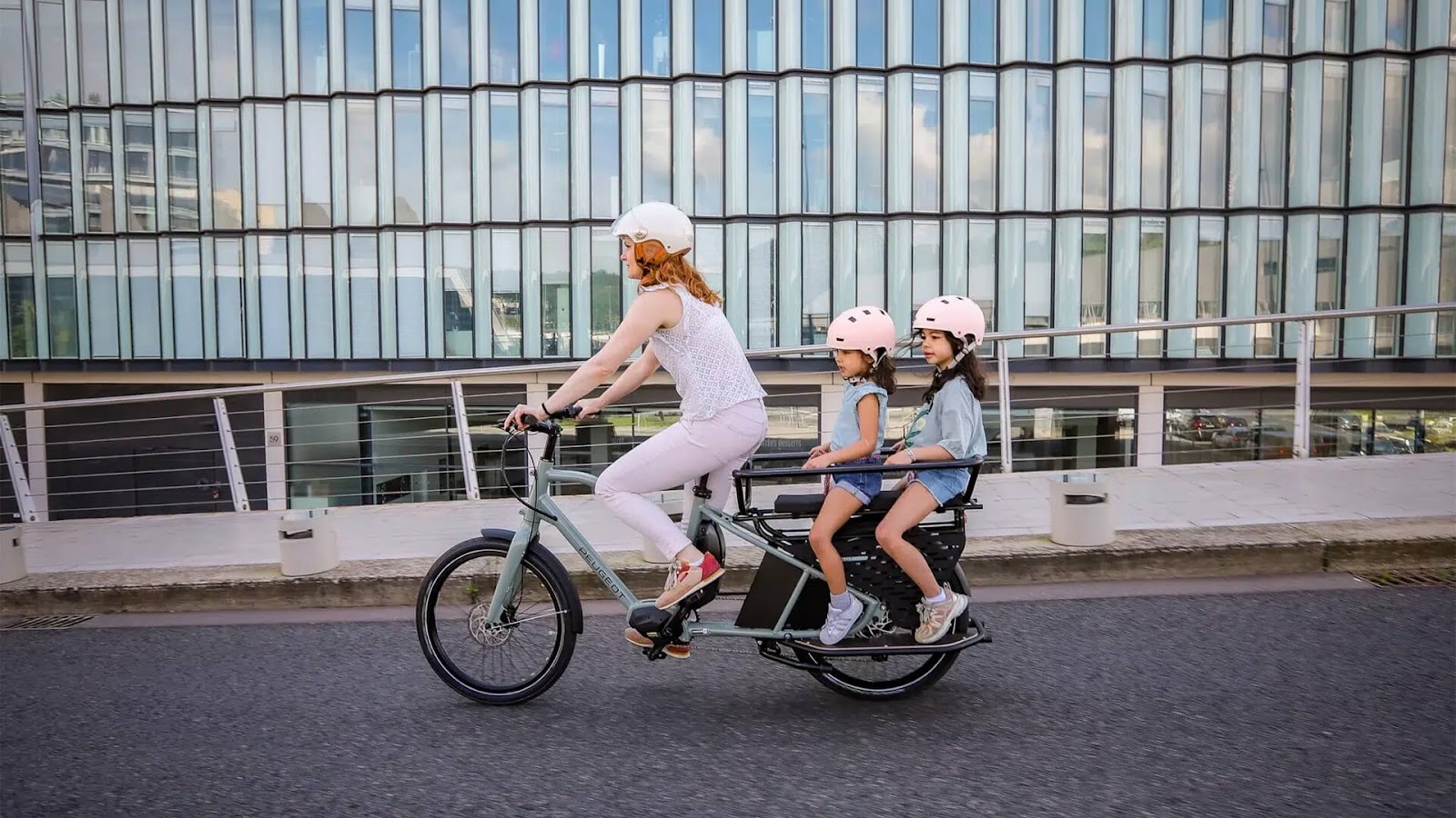 A family visiting Paris by bike with a rented longtail cargo bike