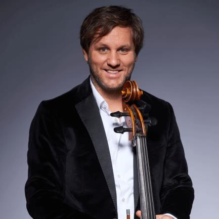 A person in a suit holding a cello  AI-generated content may be incorrect.