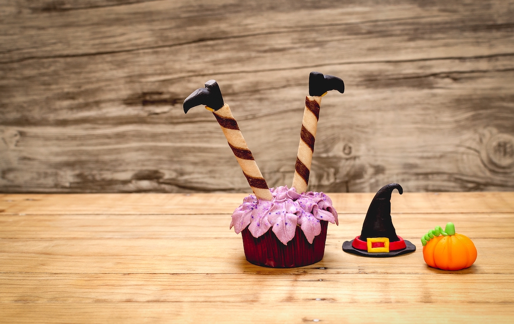 Halloween themed cupcake against a wood background