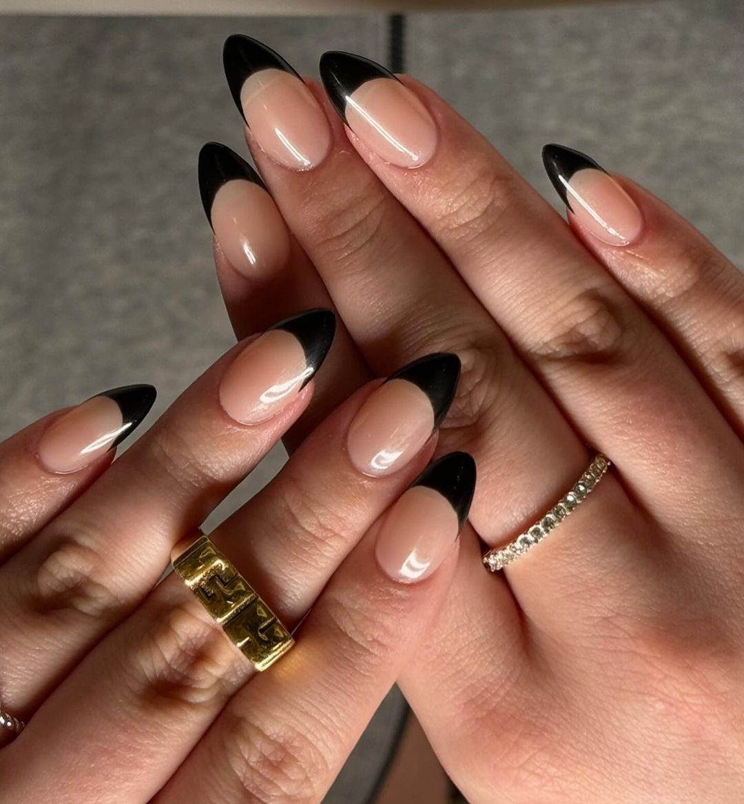 Close-up of a person's hands with black nails having Short Stiletto