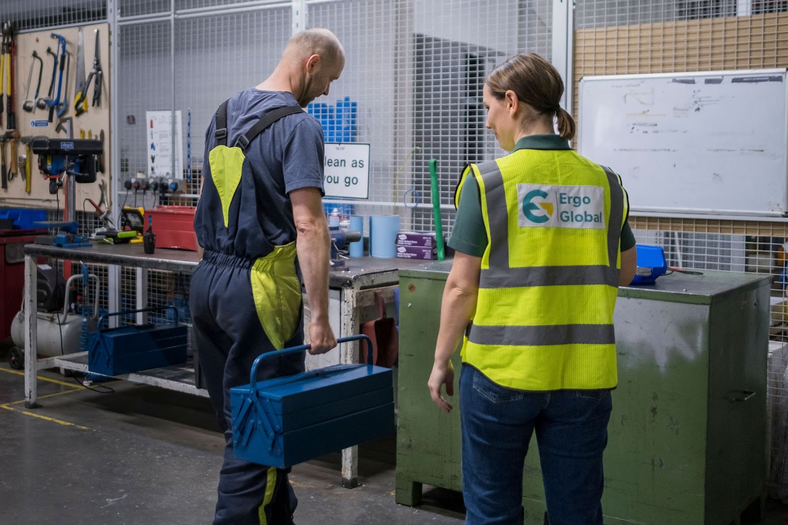An Ergo Global consultant reviews assessment data with a plant manager, demonstrating a partnership approach.