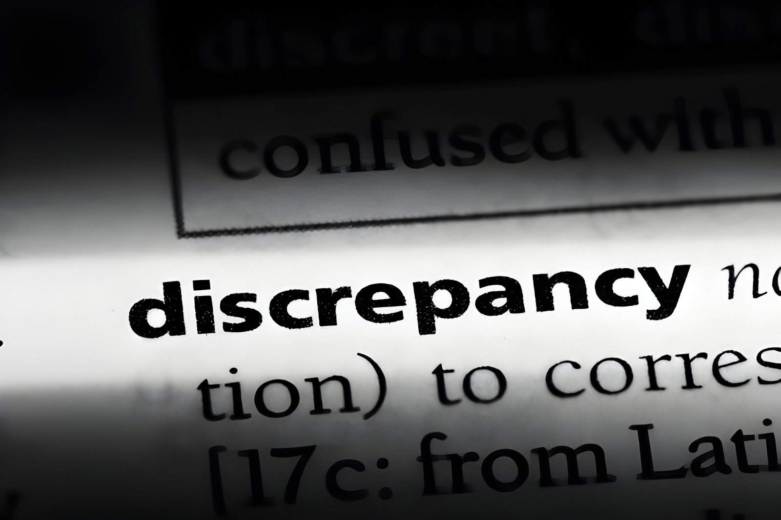 Close-up of the word 'discrepancy' highlighted in a dictionary, representing the process of handling discrepancies in accounts receivable.