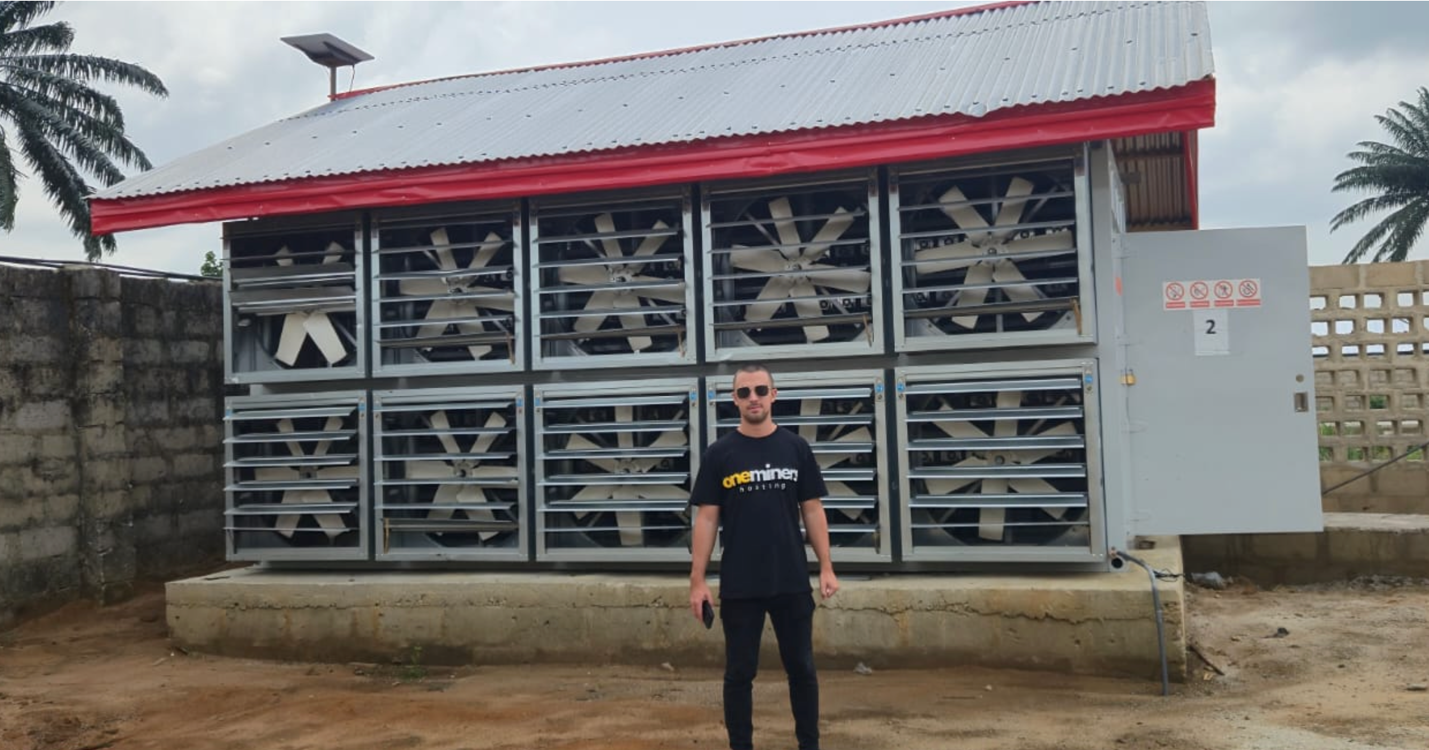 A person standing in front of a building Description automatically generated