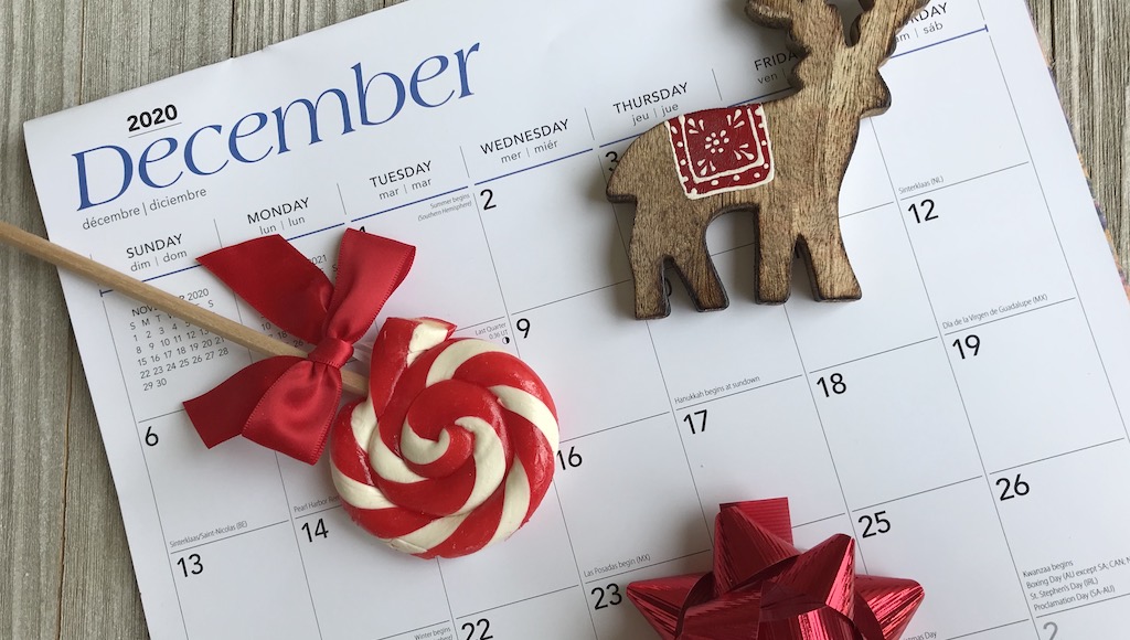 Holiday decor sitting on top of December calendar month