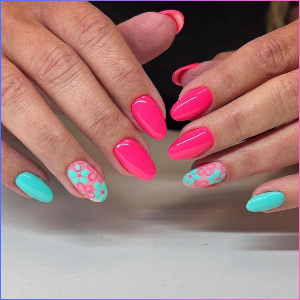 Close up of hands with flowered designed blue nails having Bright Pink and Turquoise Shades