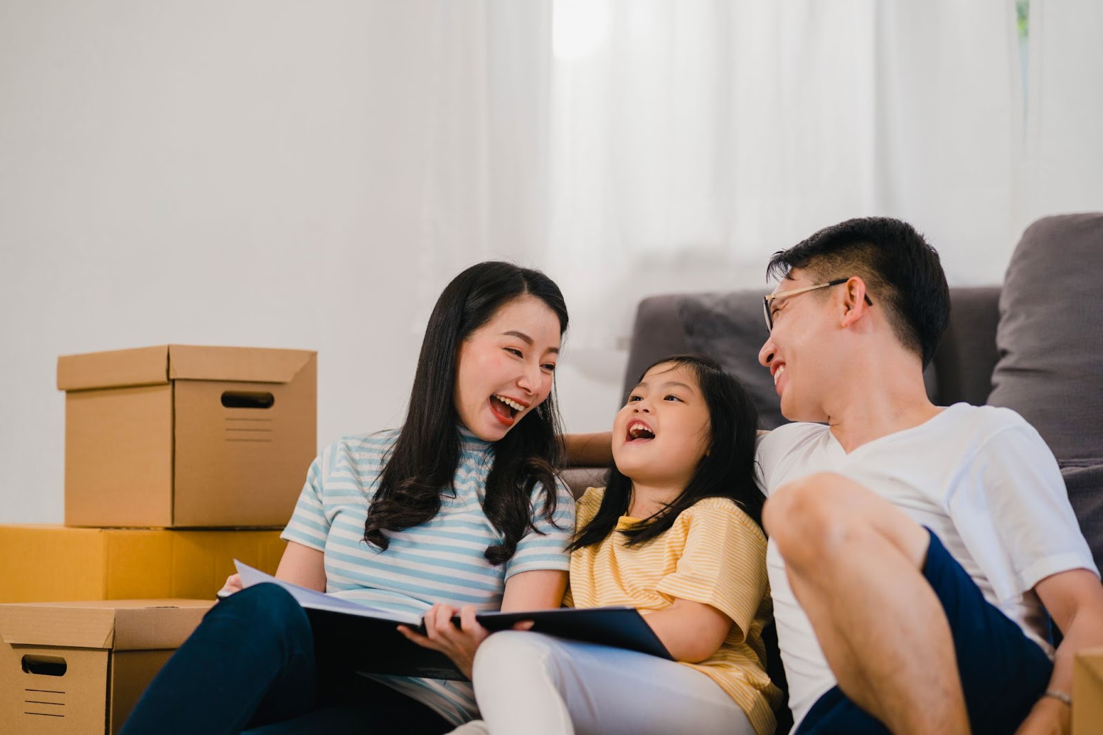 Two parents laughing with their daughter