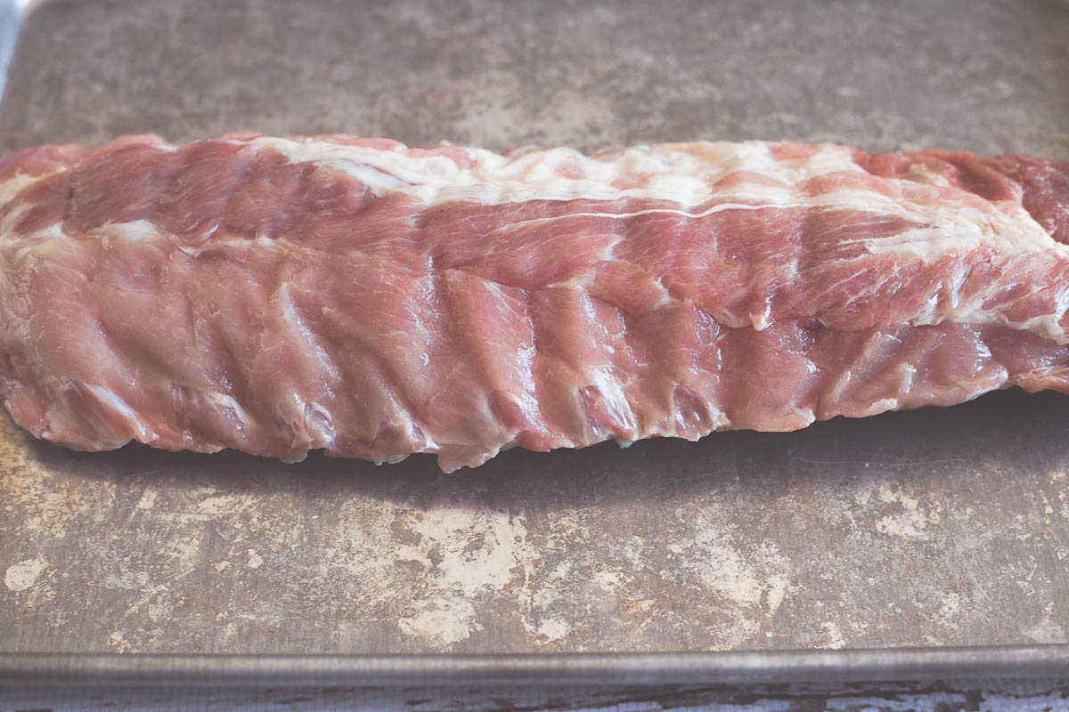 Slab of pork ribs getting prepared for vacuum sealing