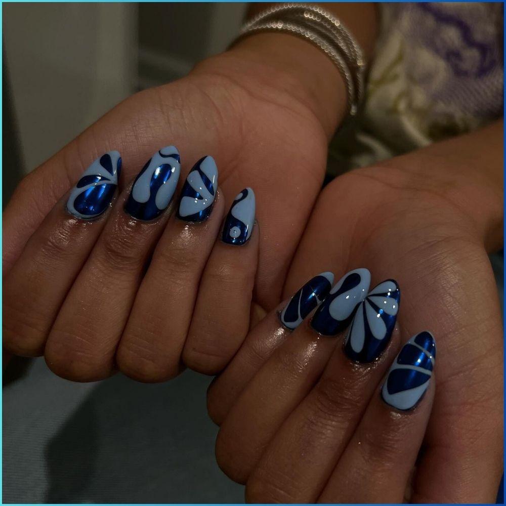 Close up of hands with flowered designed blue nails having Abstract with Chrome