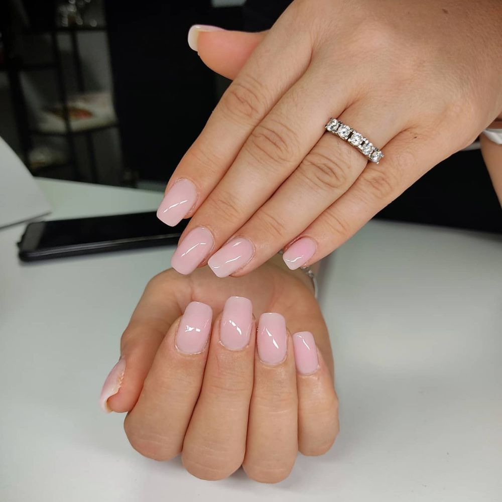 Close up of nails with simple pink nail designs having Milky Pink Nails