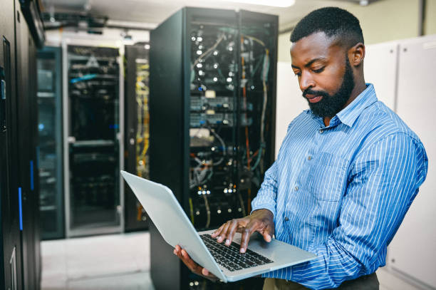 Man uses a computer to sync up with the cloud.