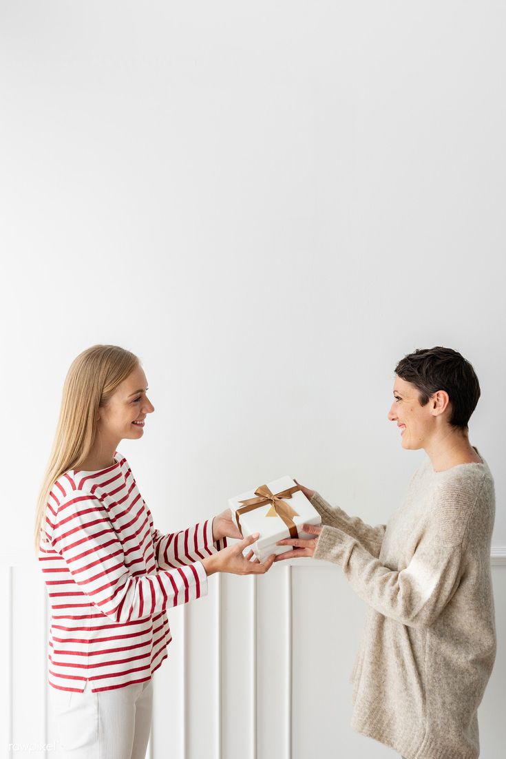 Heartwarming Mother's Day photoshoot with a daughter gifting her mother, both sharing a smile