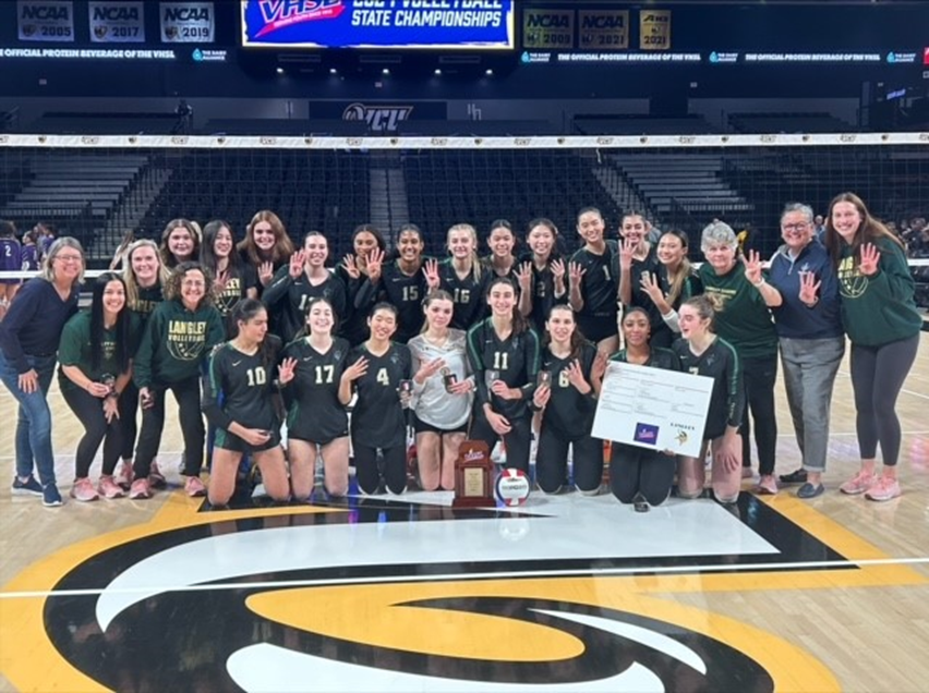 Langley High School girls volleyball team holding up the state championship trophy in Richmond, Virginia.