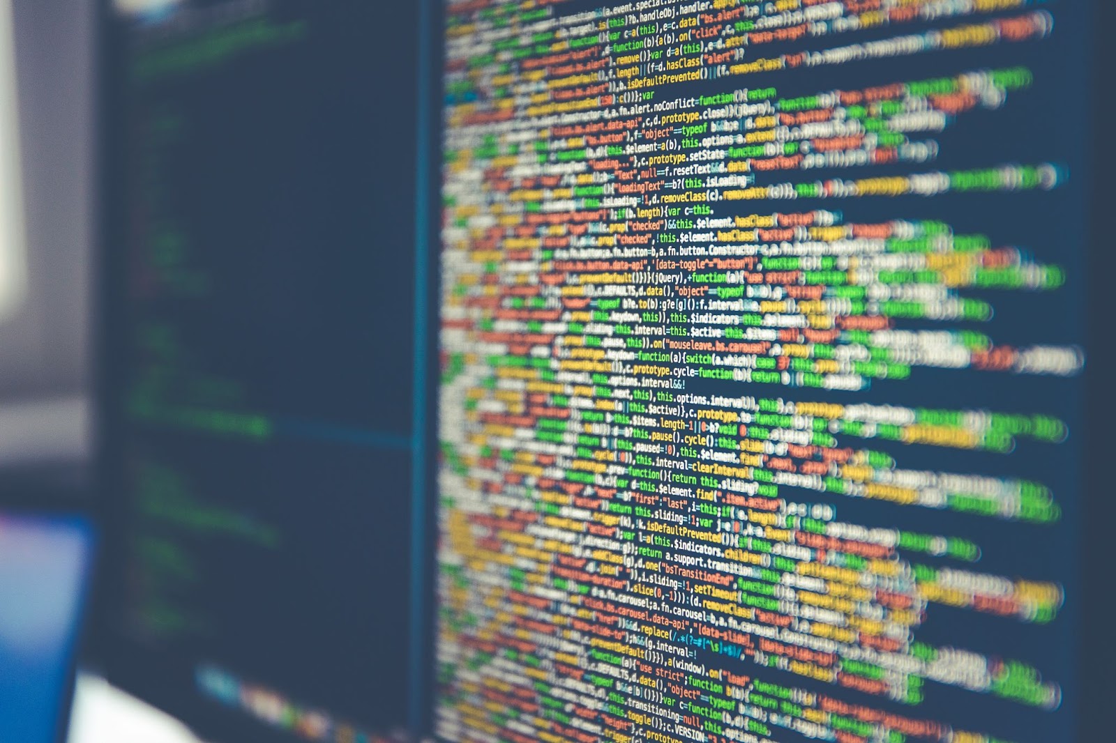 A computer screen displaying lines of colorful, blurred code.