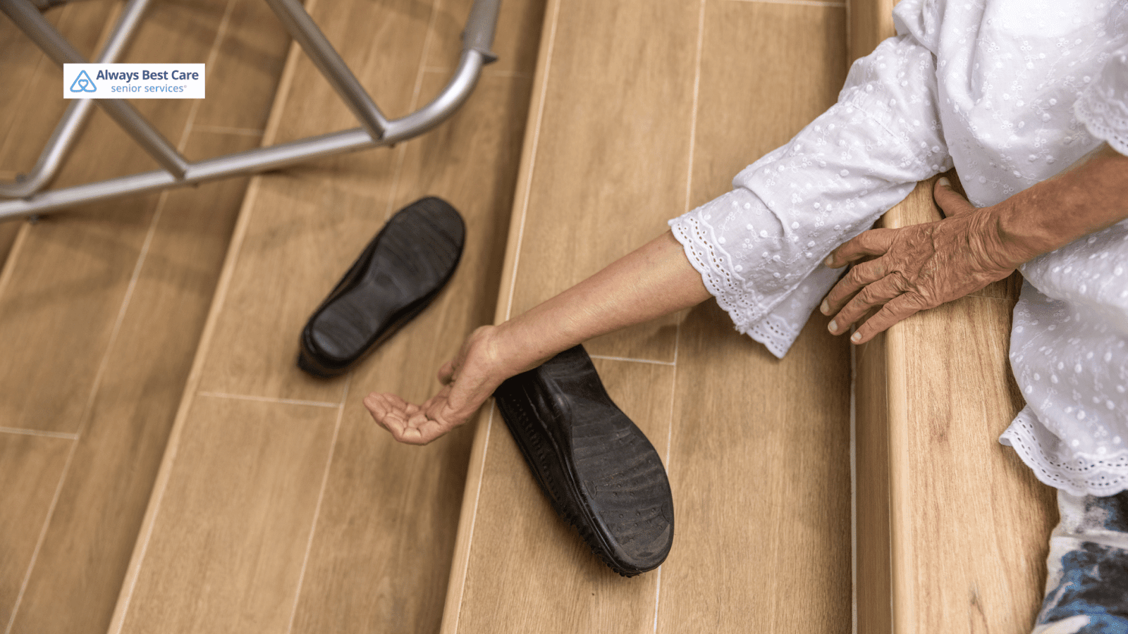 This image depicts a senior woman on the floor after having fallen on stairs