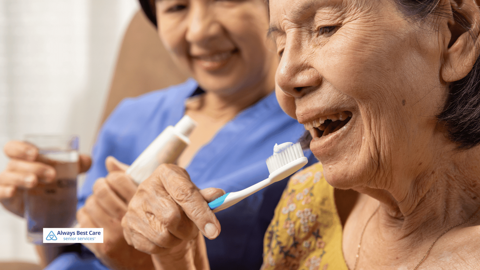 This is an image of a senior woman brushing her teeth with a caregiver assisting