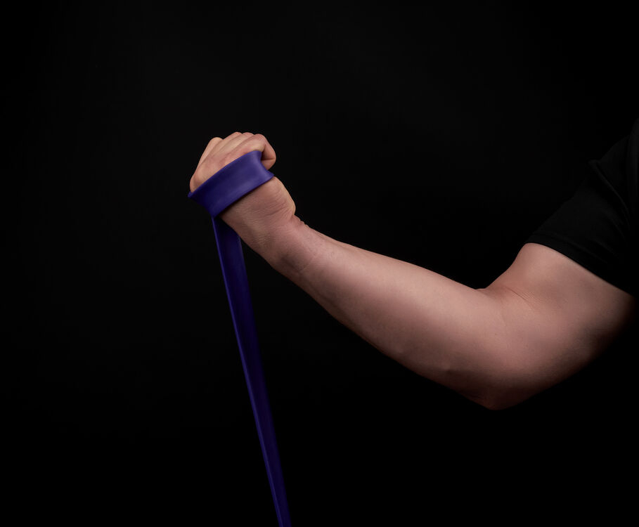 Valgus Extension Overload Exercise - man holding a tension band