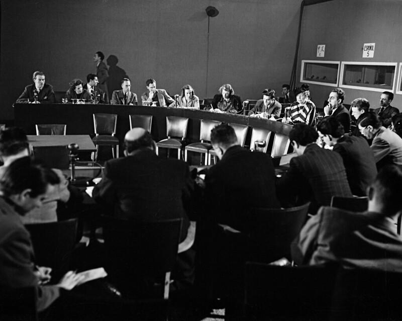  A black and white photo of Mrs Eleanor Roosevelt and others during a press conference after the completion of the Declaration of Human Rights on December 9, 1948 in Paris, France.