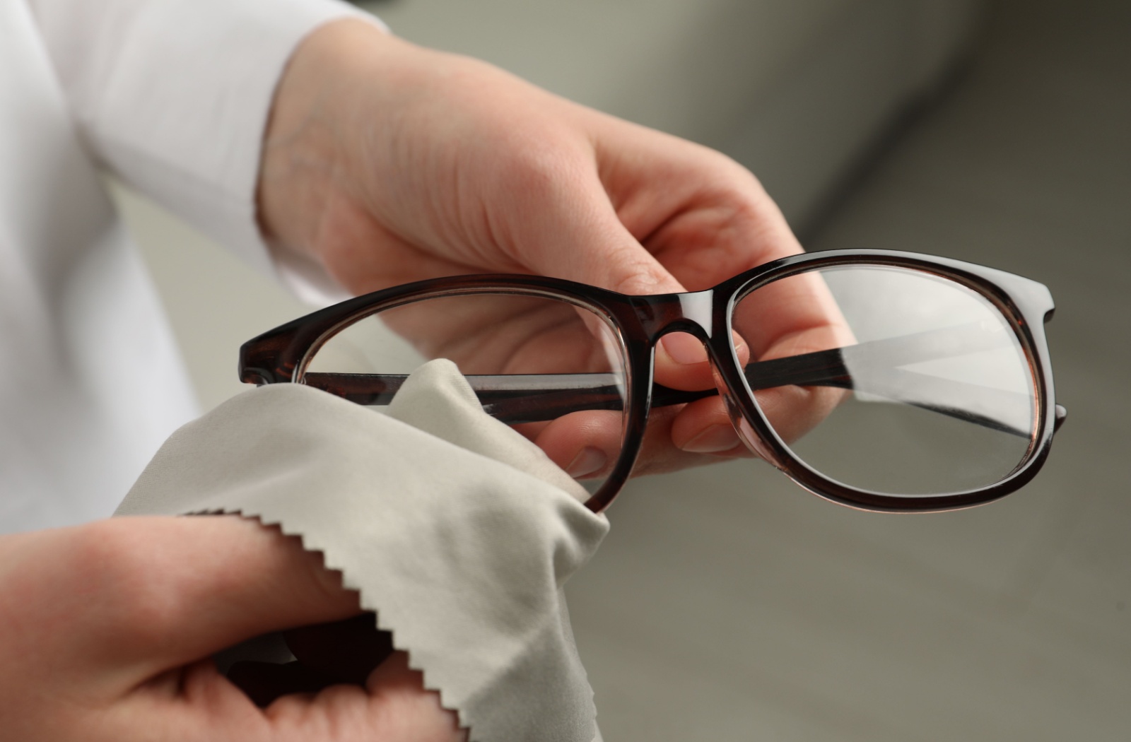 Close-up of a pair of glasses being cleaned.