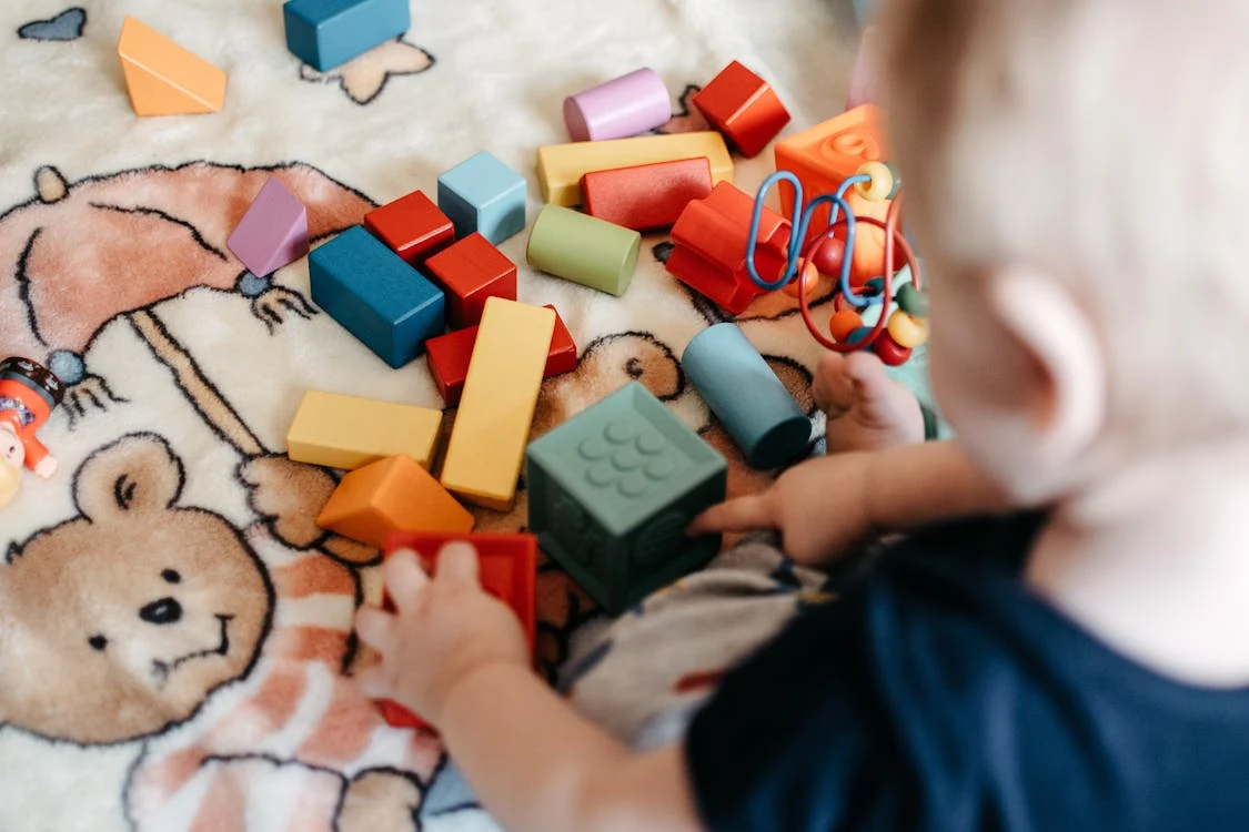 Baby playing with colored blocks