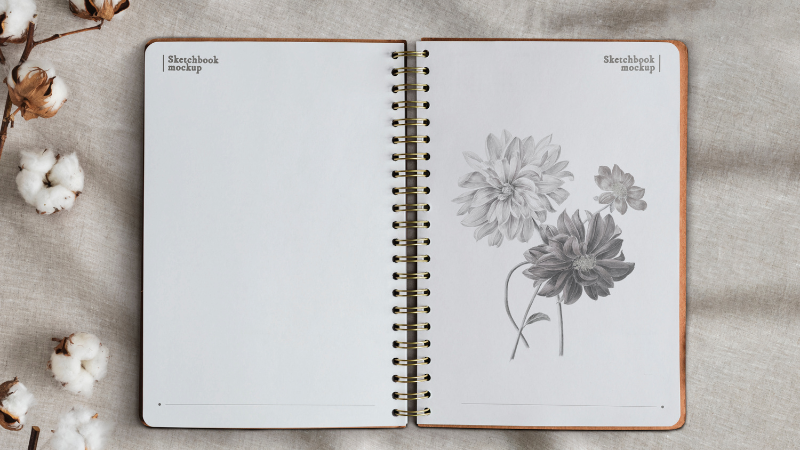 A sketchbook with flowers on one of the notebook pages