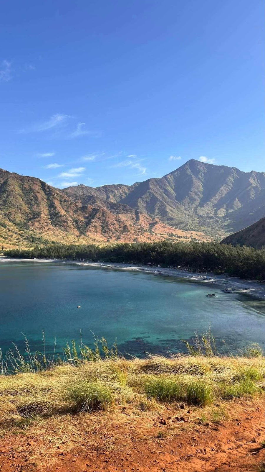 A body of water next to a mountain

AI-generated content may be incorrect.