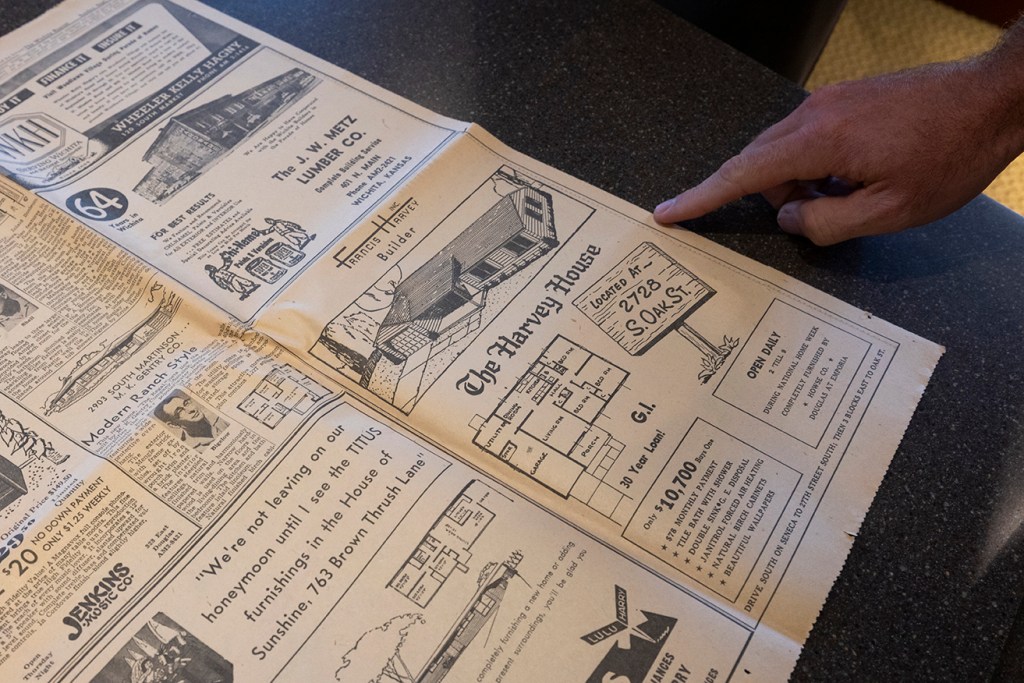 man pointing at newspaper