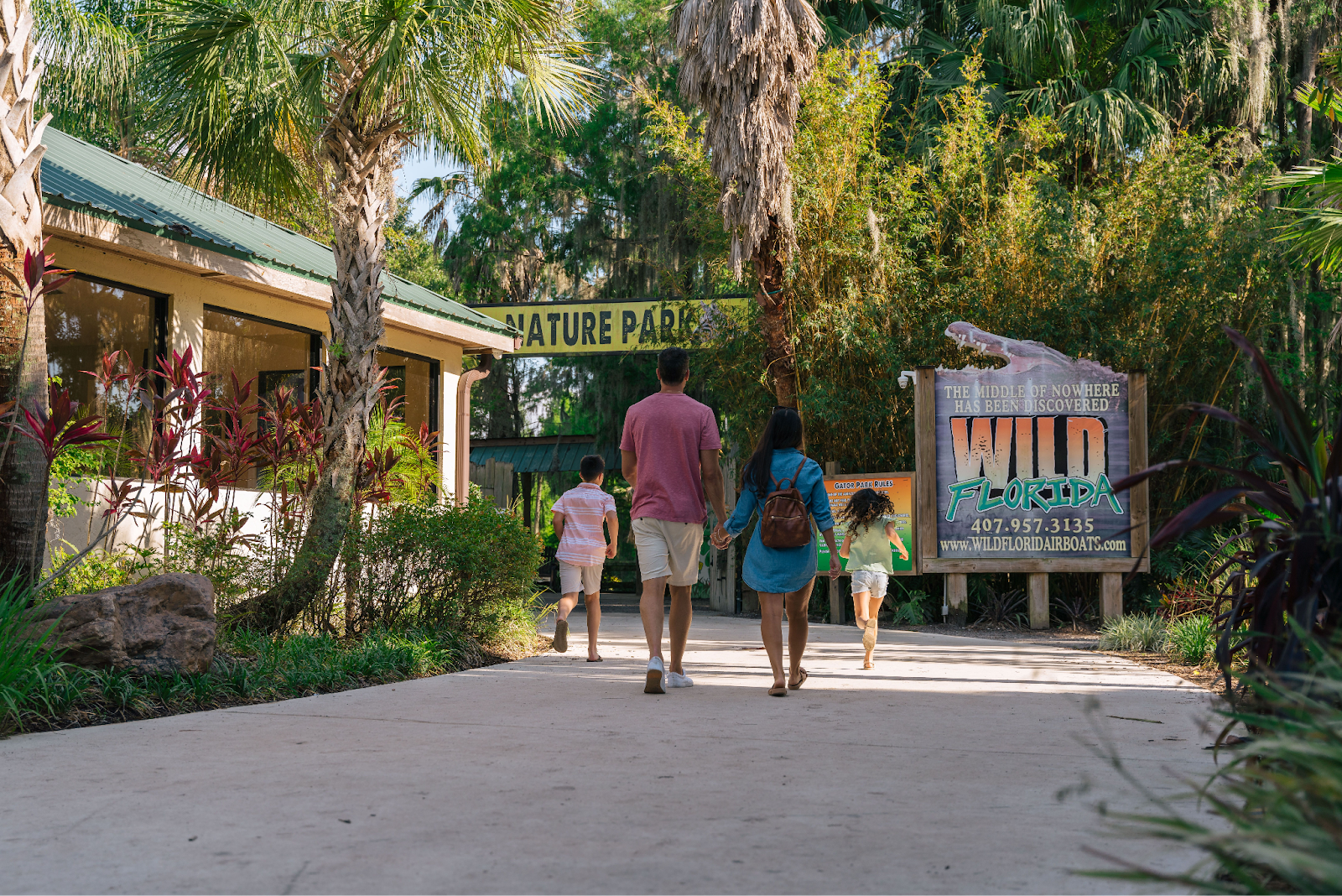 A family walking through the entrance of Wild Florida’s Gator Park