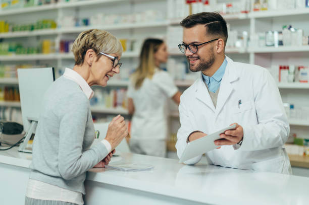 A customer consulting with a pharmacist about the best vitamins for gut health, reviewing supplement options.