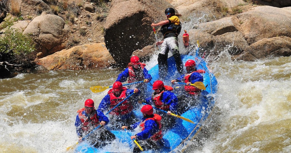 team working together on white water rafting retreat