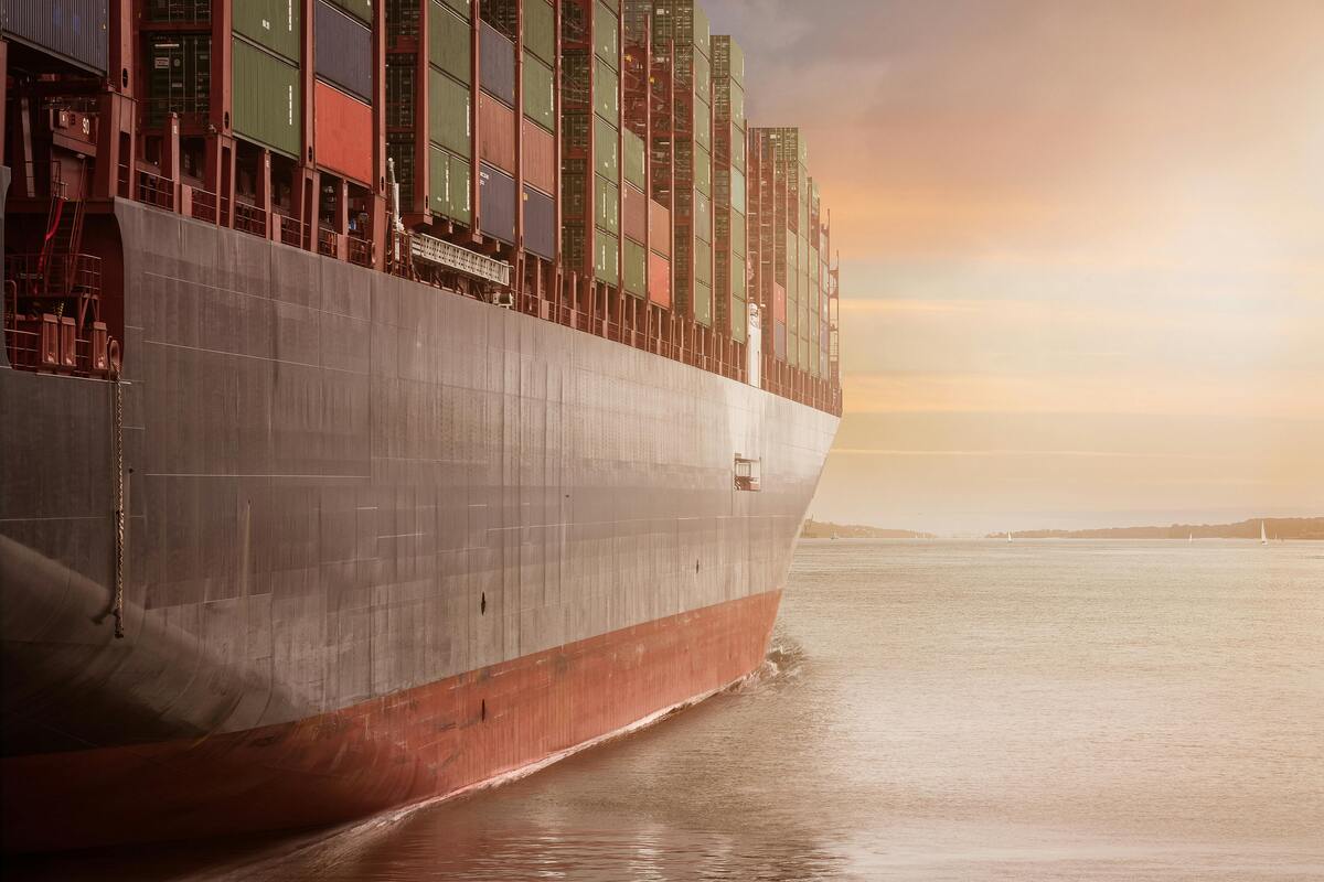Massive cargo ship loaded with colorful freight containers, illustrating international container shipments and global logistics.