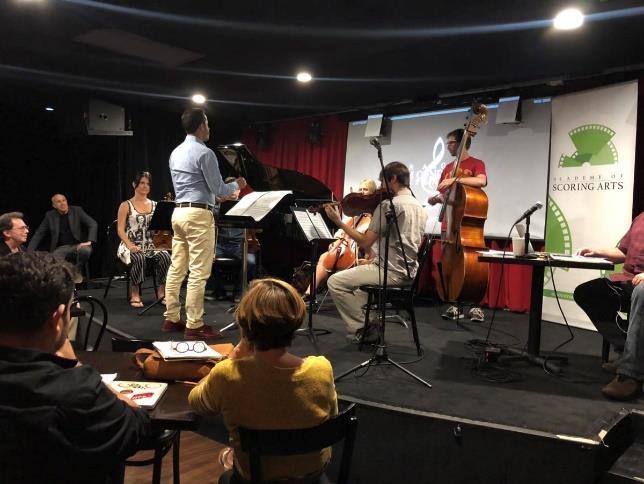 A group of people playing instruments  AI-generated content may be incorrect.