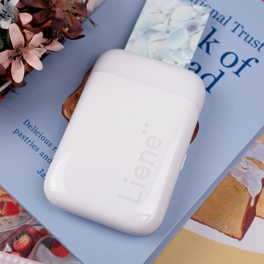 A white device on top of a book

Description automatically generated