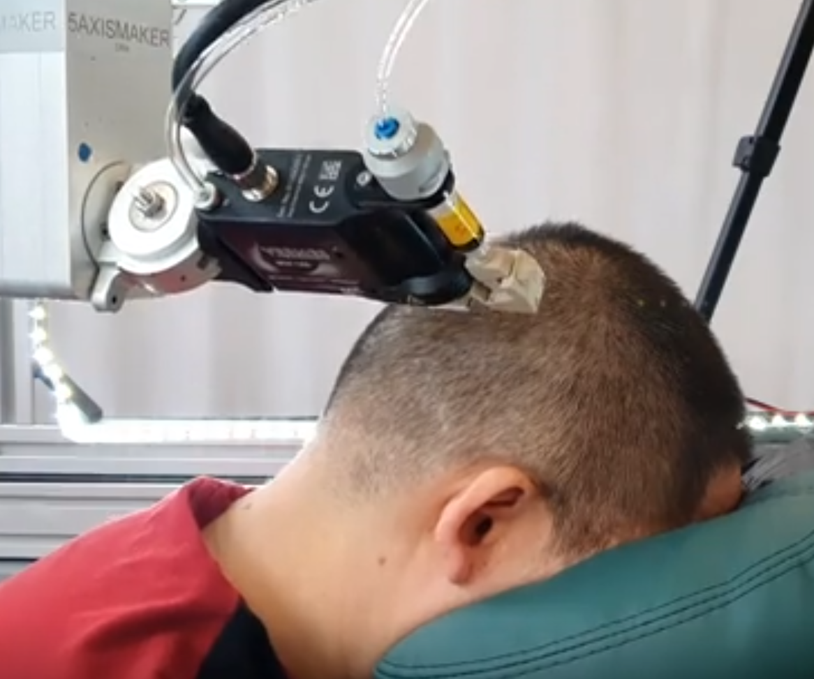 A person with his head on a machine

Description automatically generated