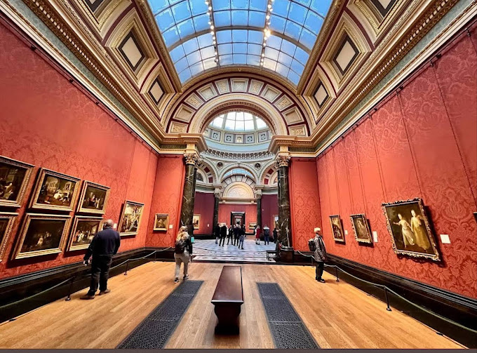 Exterior view of the National Gallery in London with its grand columns and vibrant surroundings at Trafalgar Square