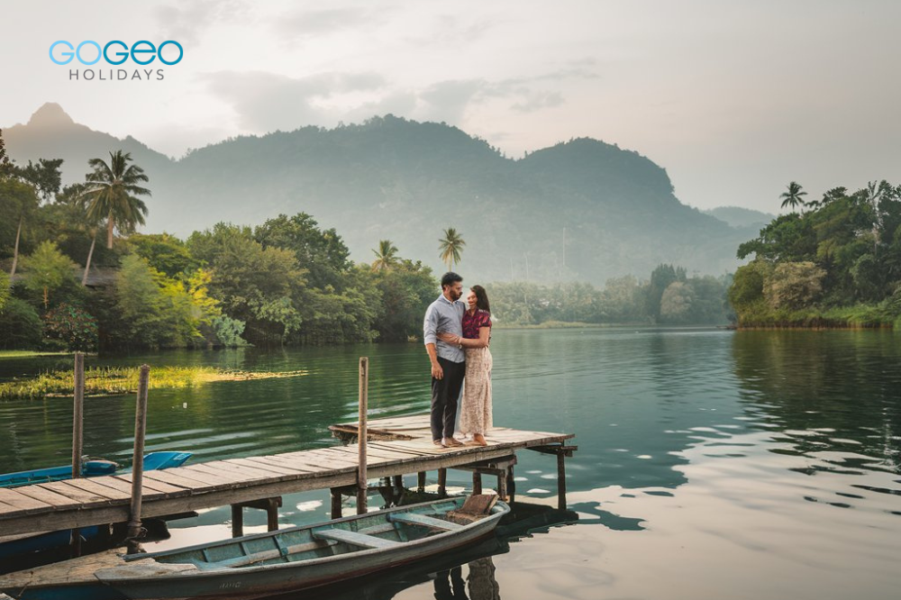 a married couple standing on a bridge