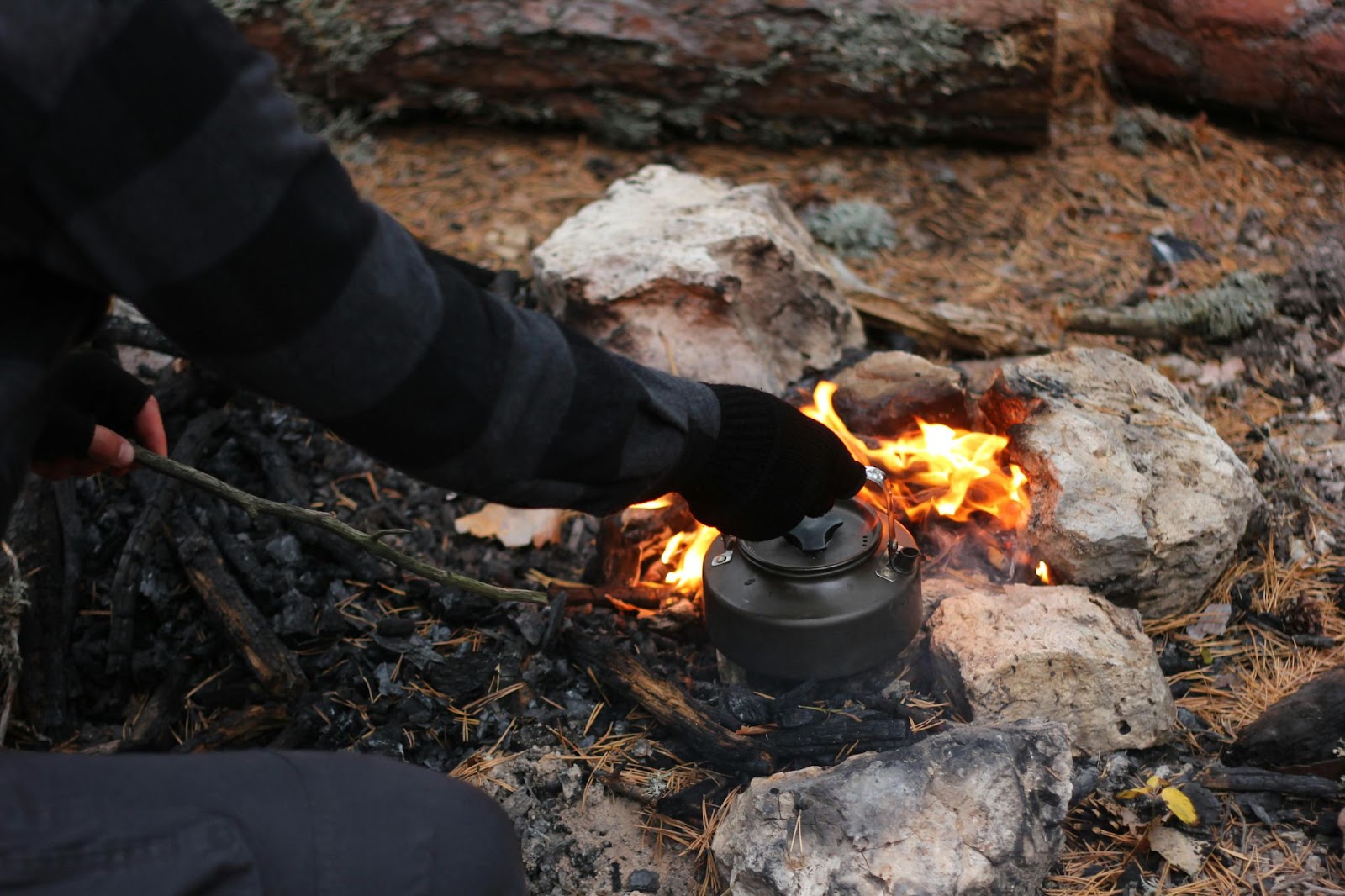 A man in outdoor making a camping dinner in a kettle