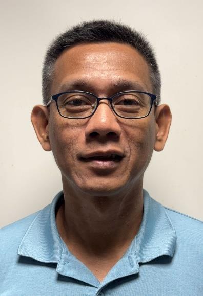 A person wearing glasses and a blue shirt  AI-generated content may be incorrect.