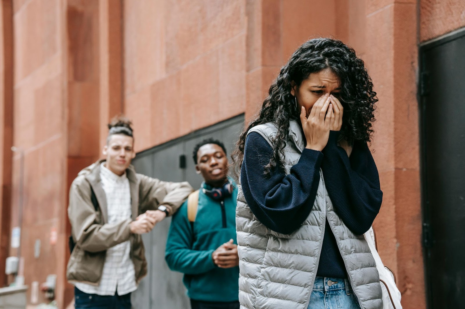 Two men bullying a woman 