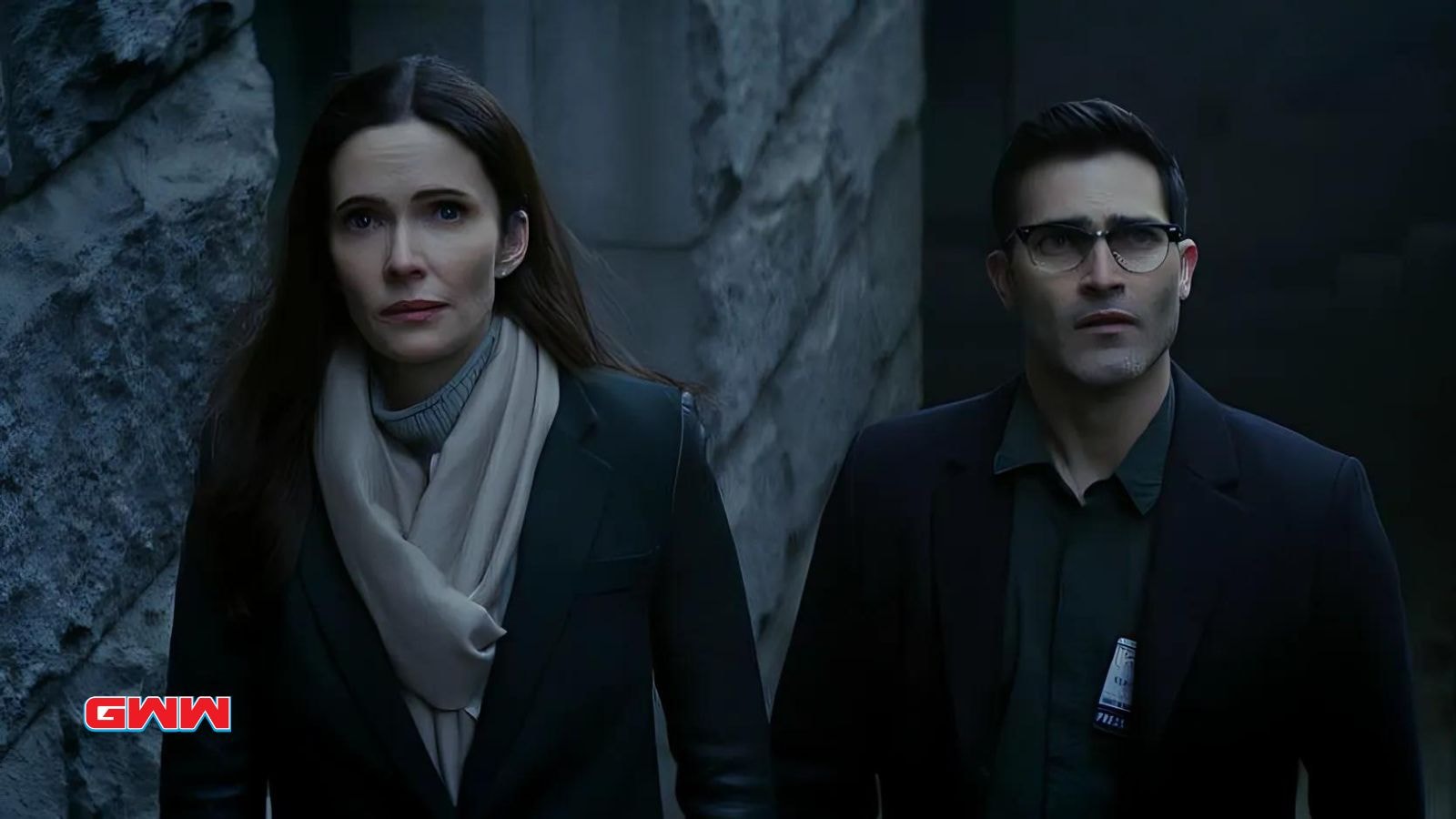 Elizabeth Tulloch and Erik Valdez looking serious in a dark setting