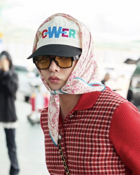 This contains an image of G-Dragon wearing sunglasses and a hat with the word g power on it is standing in front of some cars