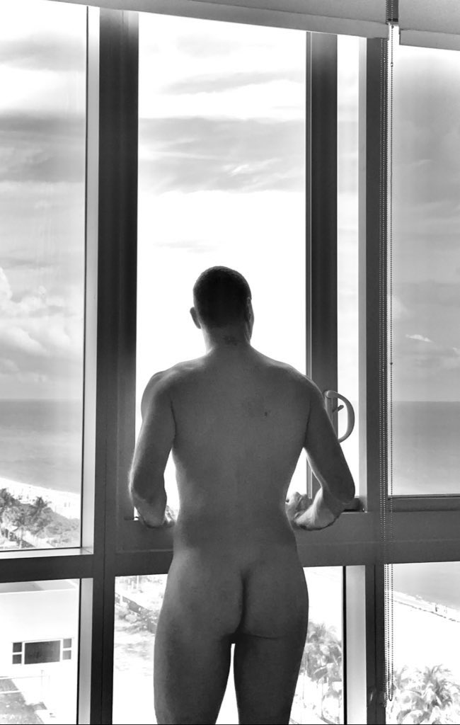 MrNiceCockSF posing naked at the window showing off his gay bubble butt for gay porn content