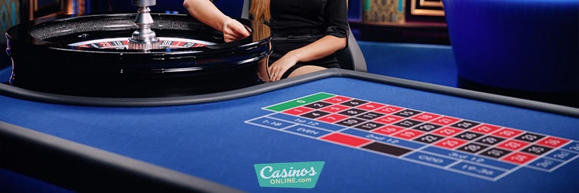 azure roulette table dealer spinning the ball