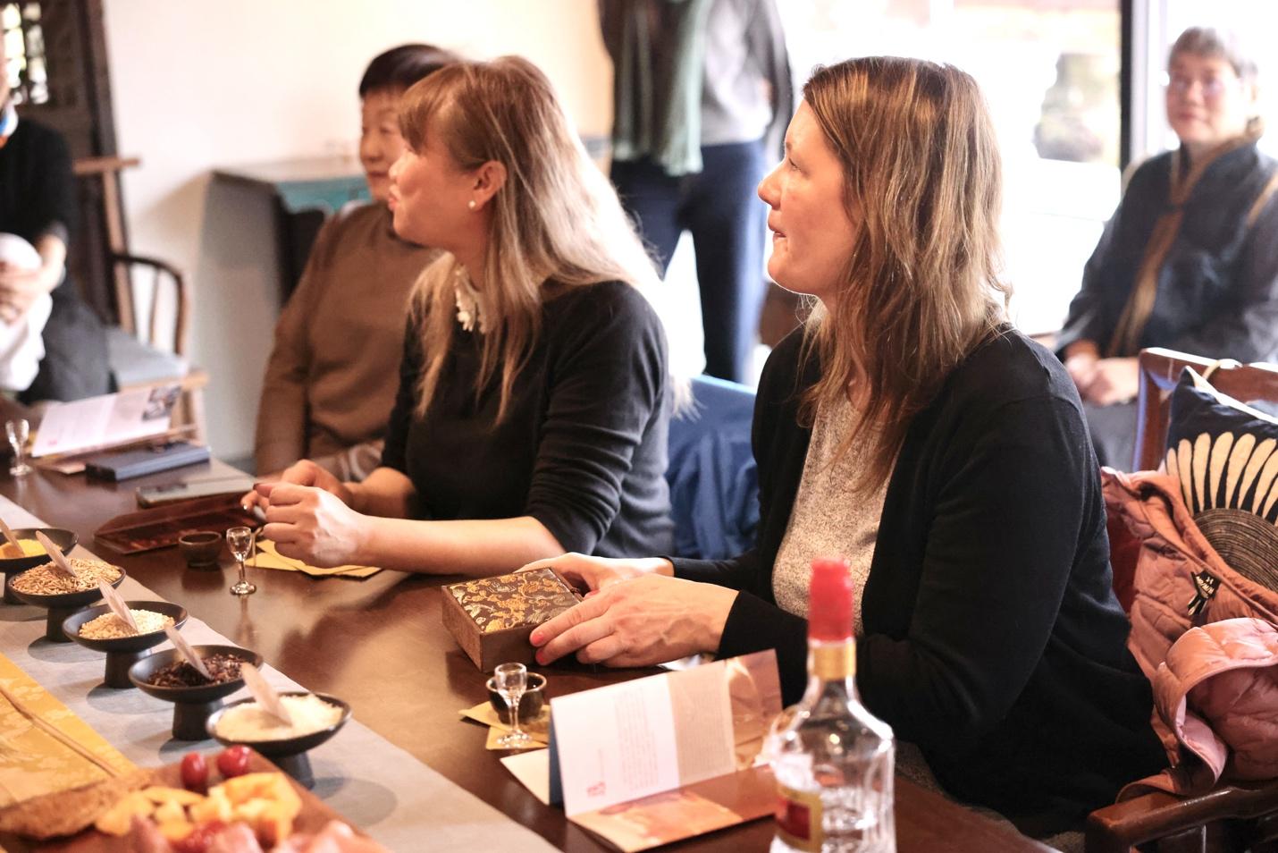 A group of women sitting at a table

AI-generated content may be incorrect.