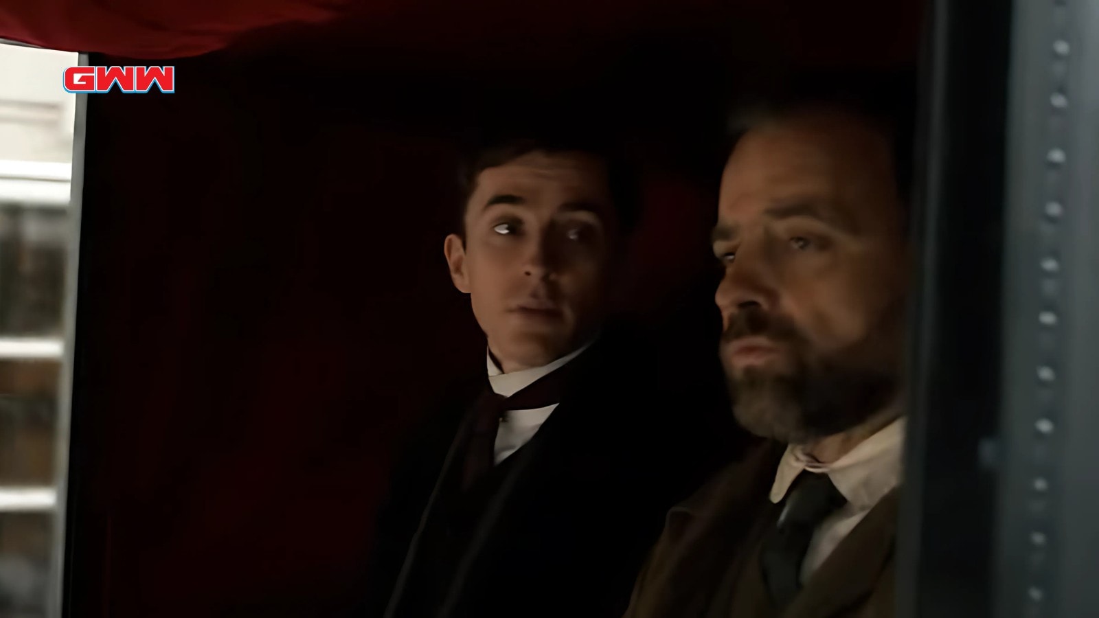 Matthew Beard and Juergen Maurer in a carriage discussing an investigation