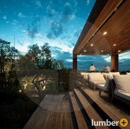 Wooden deck along a beach with recessed lighting. 