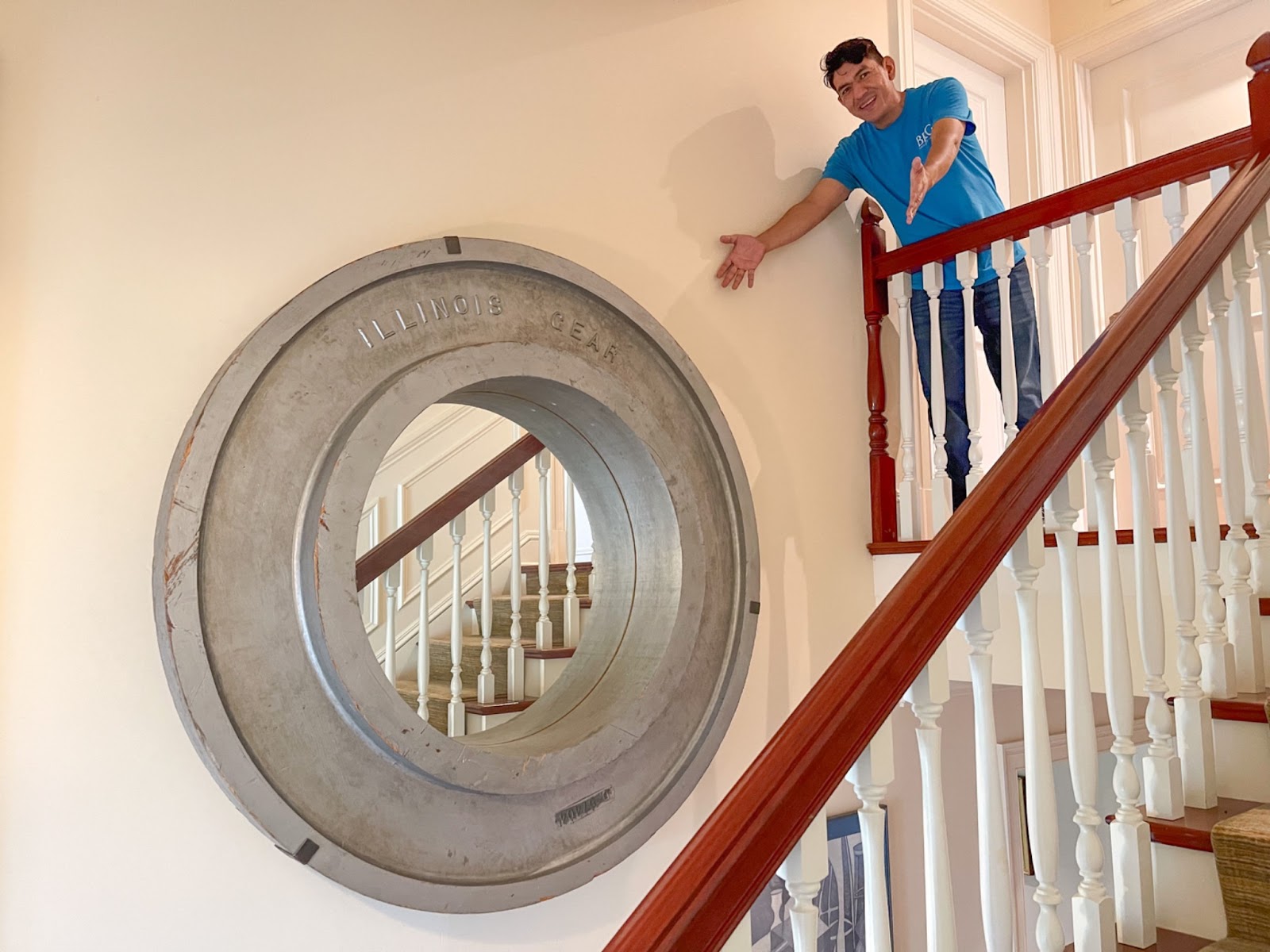 Oversized industrial mirror made from a train gear mold that reads “Illinois Gear”